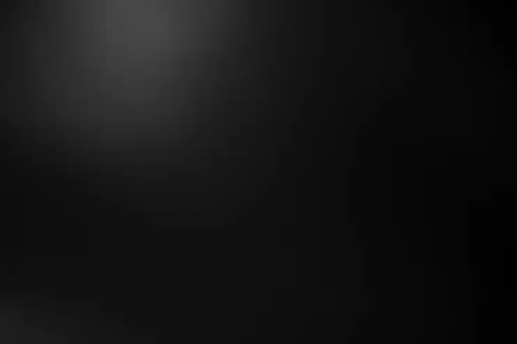 Dark, minimalist image with subtle gradient from lighter gray at top to black at bottom